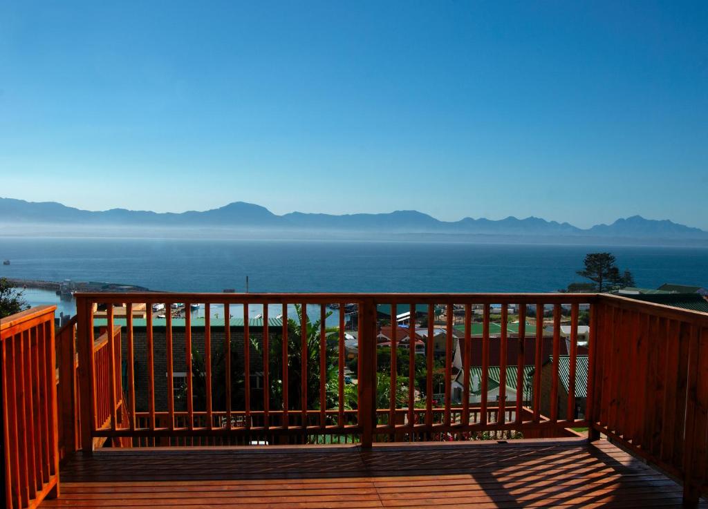 a wooden deck with a view of the ocean at Sundowner Loft in Mossel Bay