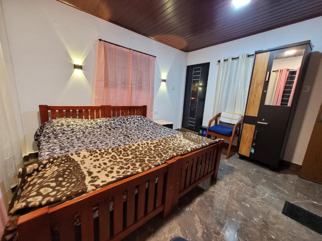 a bedroom with a bed with a leopard print blanket at Mistvalley Hut in Chithragiri
