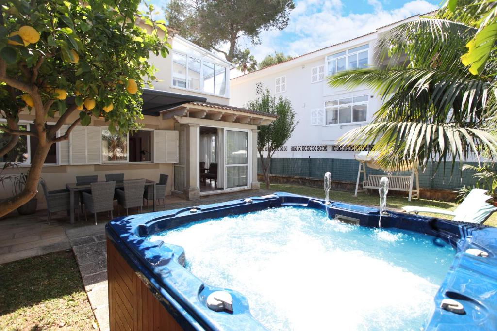 a swimming pool in the backyard of a house at Villa Beach Alcudia, lovely house with jacuzzi in Alcudia