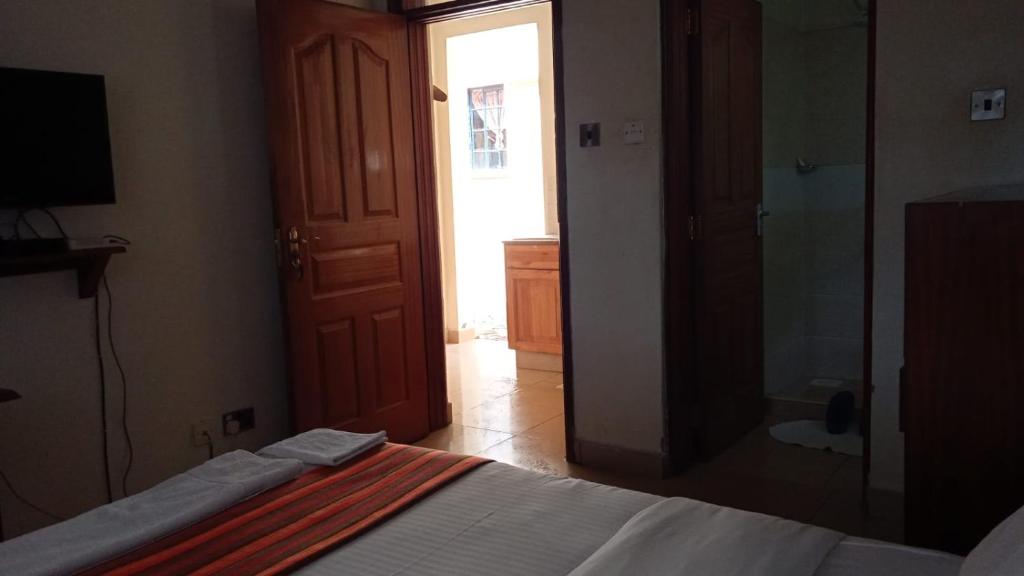 Postel nebo postele na pokoji v ubytování dreamplace Gigiri