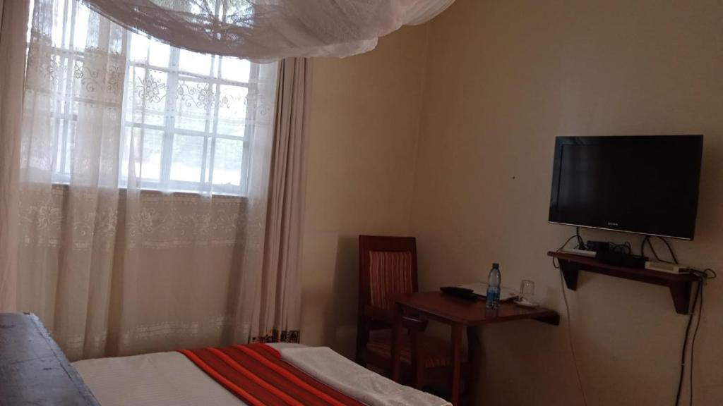 TV a/nebo společenská místnost v ubytování dreamplace Gigiri