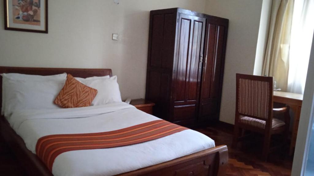 Postel nebo postele na pokoji v ubytování dreamplace Gigiri