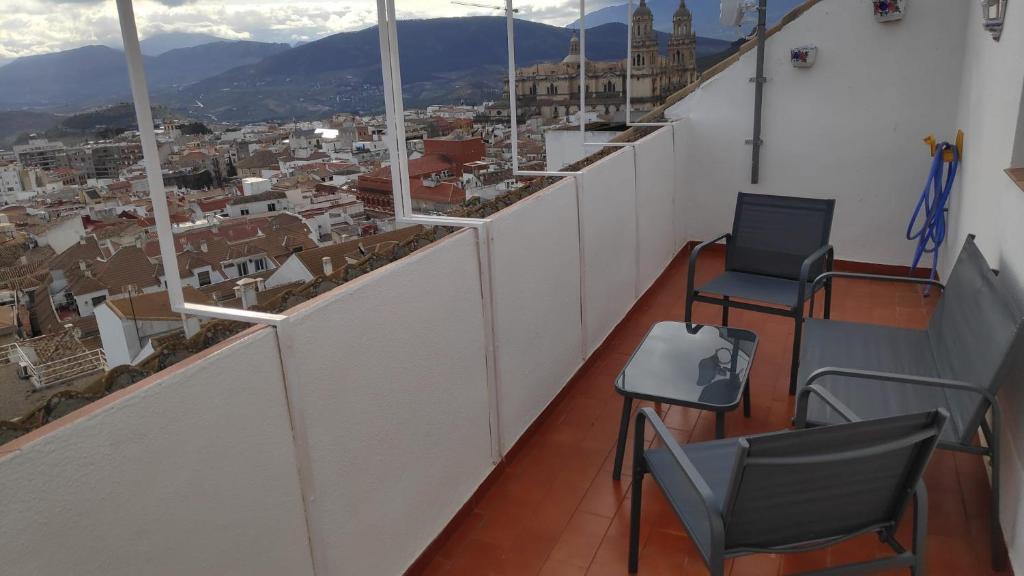 a balcony with chairs and a view of a city at Dúplex San Lorenzo 2 PARKING GRATUITOS in Jaén