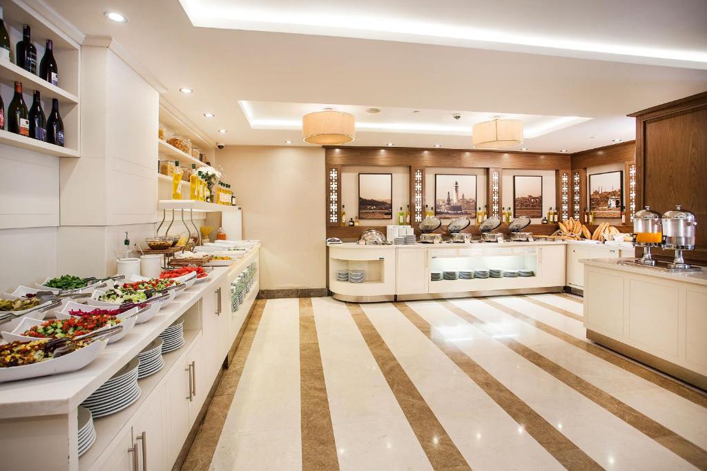 a large kitchen with a lot of food on the counters at Nidya Hotel Galataport in Istanbul