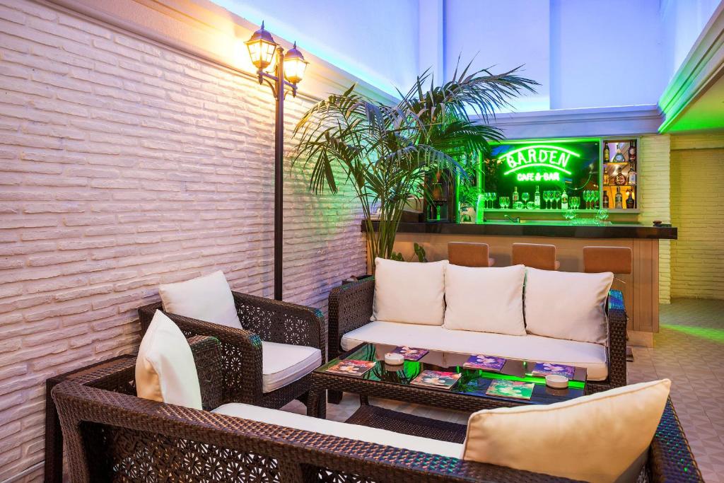 a patio with chairs and a bench and a bar at Nidya Hotel Galataport in Istanbul