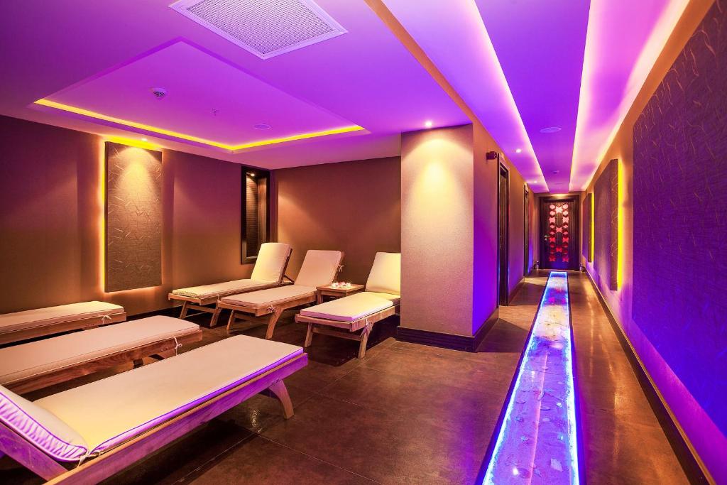 a room with purple lights and benches in it at Nidya Hotel Galataport in Istanbul