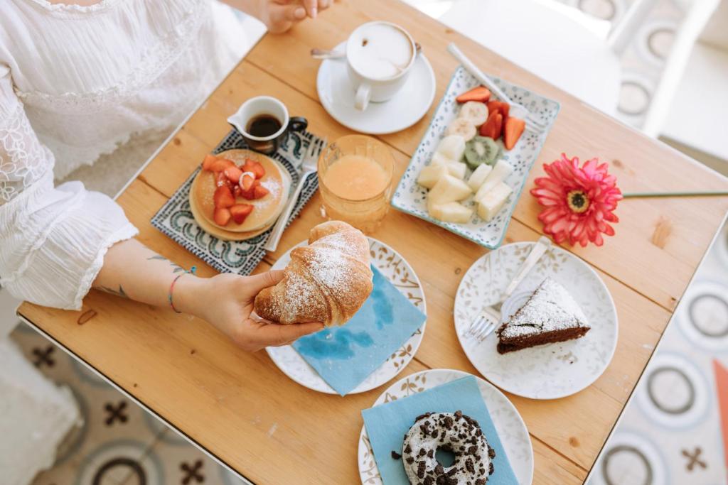 a table topped with plates of food and desserts at Dimora Anderì in Polignano a Mare
