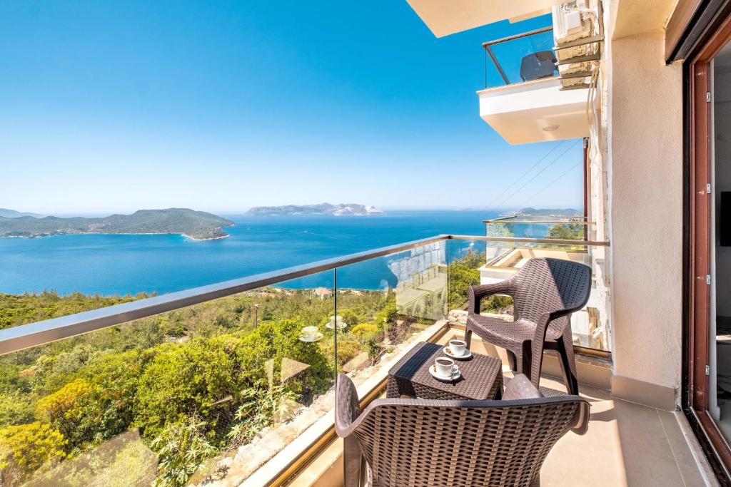 a balcony with chairs and a view of the ocean at Golden Rose Suit Hotel in Kas