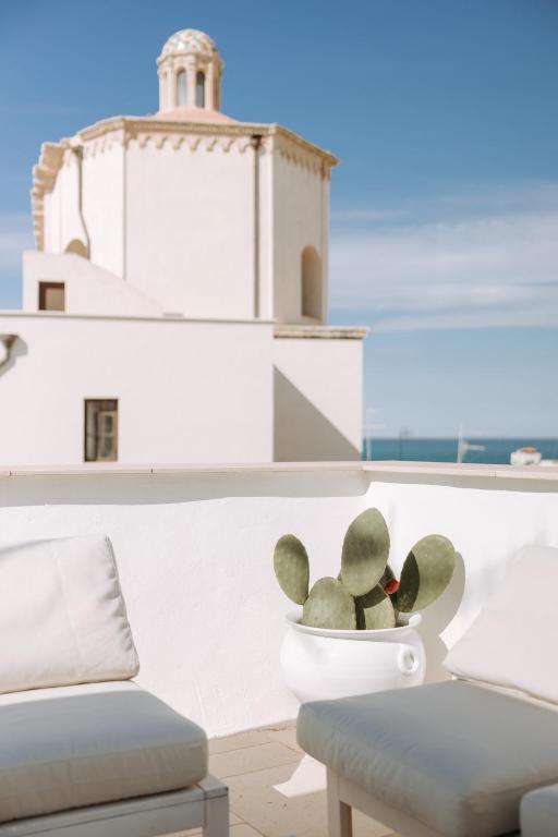a teddy bear sitting in a bowl in front of a building at Dimora Anderì in Polignano a Mare