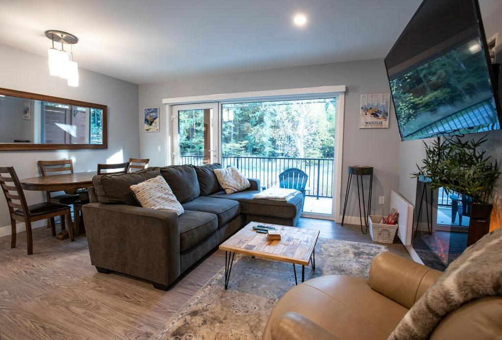 a living room with a couch and a table at Al's Escape by Revelstoke Vacations in Revelstoke