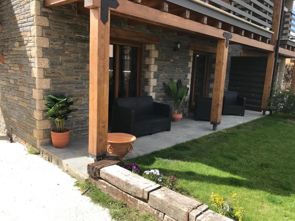 a patio with a wooden pergola on a house at Maison à Bourg Madame in Bourg-Madame