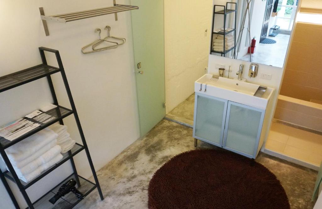 a bathroom with a sink and a mirror at Milk White Homestay in Hengchun South Gate
