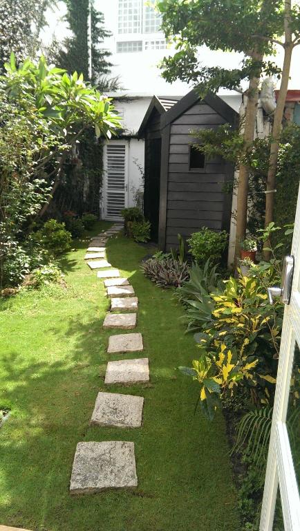 a garden with a stone path in the grass at Milk White Homestay in Hengchun South Gate