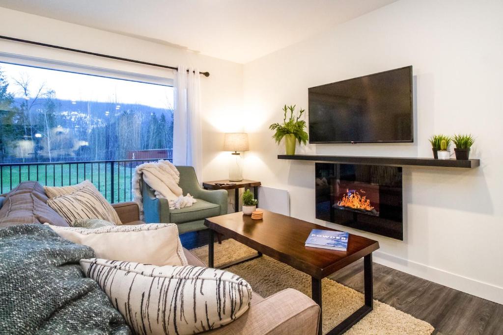 a living room with a couch and a fireplace at Revelstoke Retreat by Revelstoke Vacations in Revelstoke
