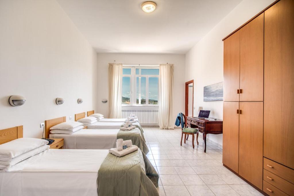 Postel nebo postele na pokoji v ubytování Villa MG Hotel