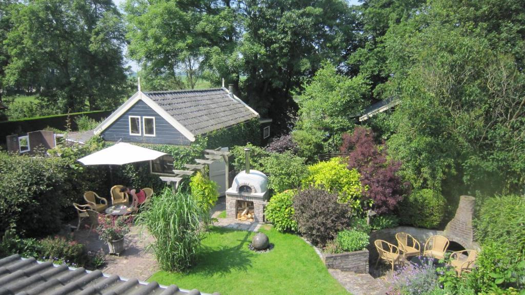 a backyard with a garden with a fire place at Apartment In de Wolken in Oostwoud