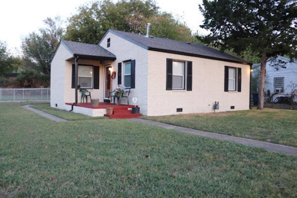 a small white house with a lawn in front of it at Charming 2 bedroom Retreat minutes from Downtown in Tulsa