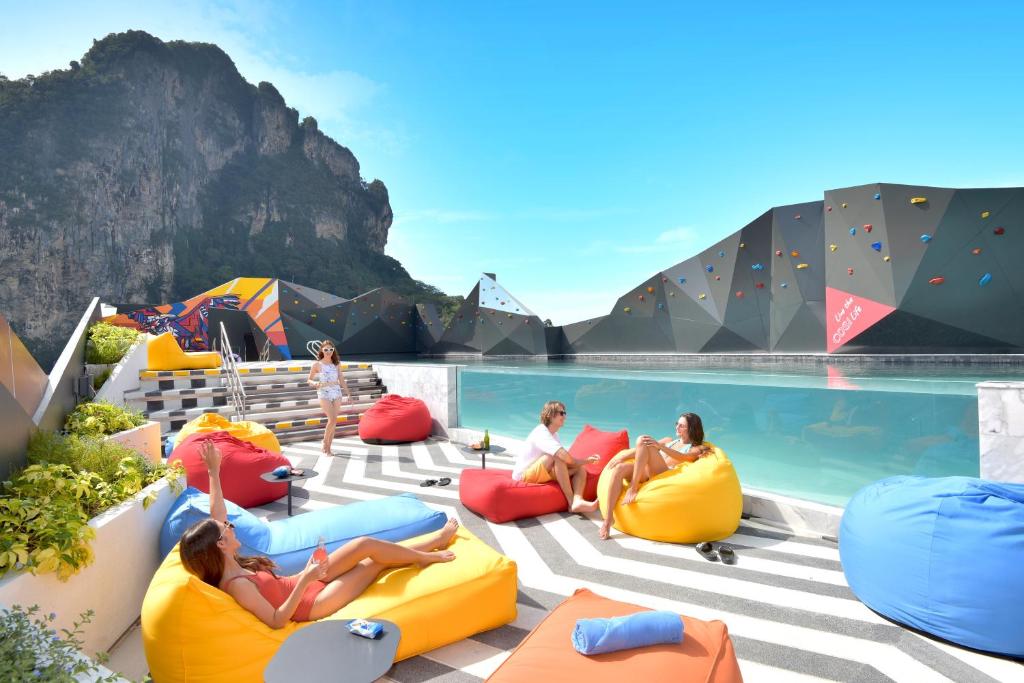 a group of people sitting on inflatables by a pool at COSI Krabi Ao Nang Beach - SHA Plus in Ao Nang Beach
