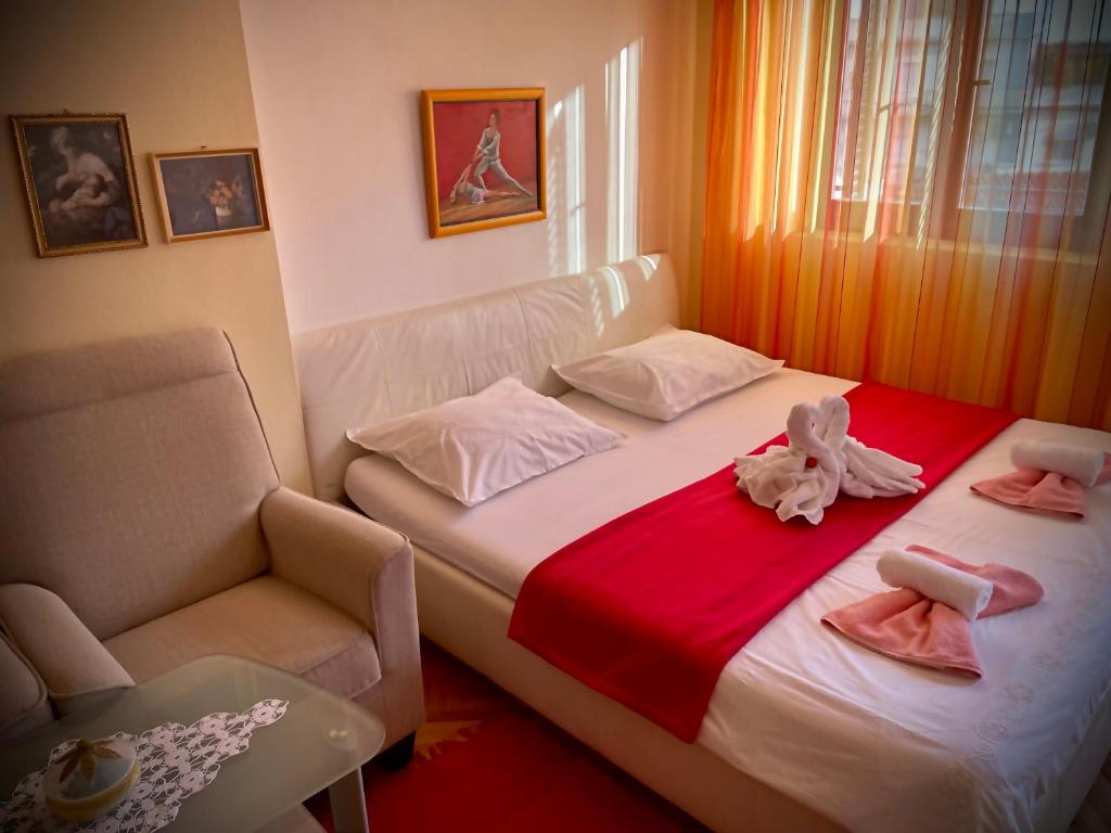 a bedroom with a bed with two dolls on it at Apartment Malenko in Šibenik
