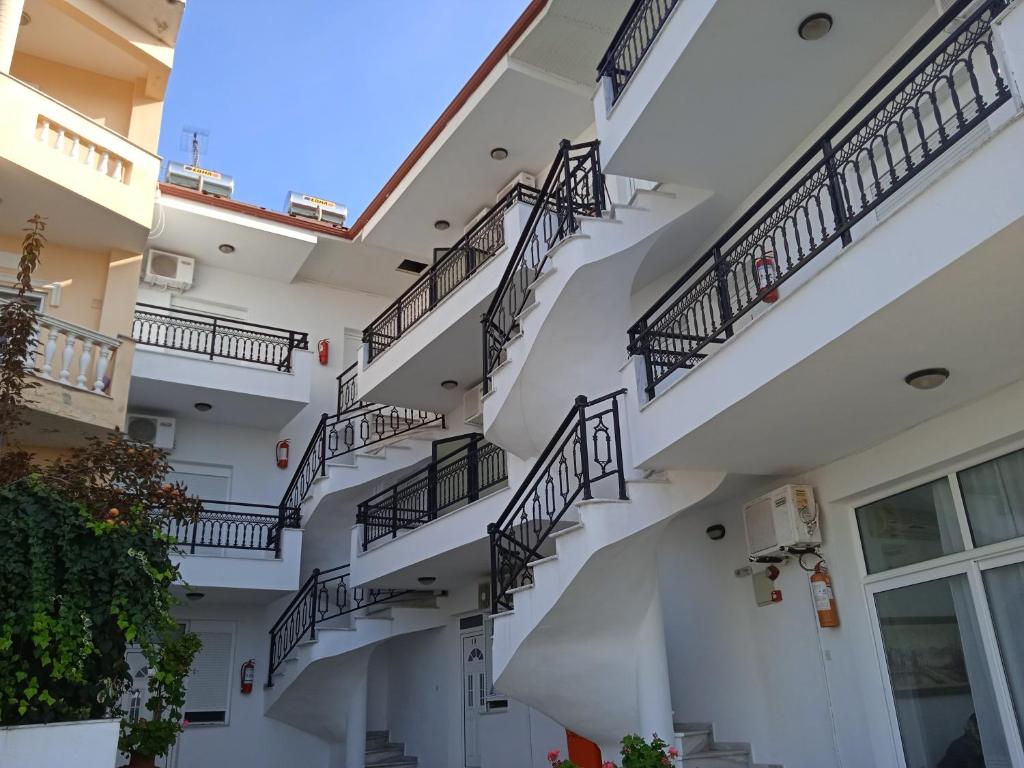 a spiral staircase in a building with balconies at Villa Chrissa in Limenaria