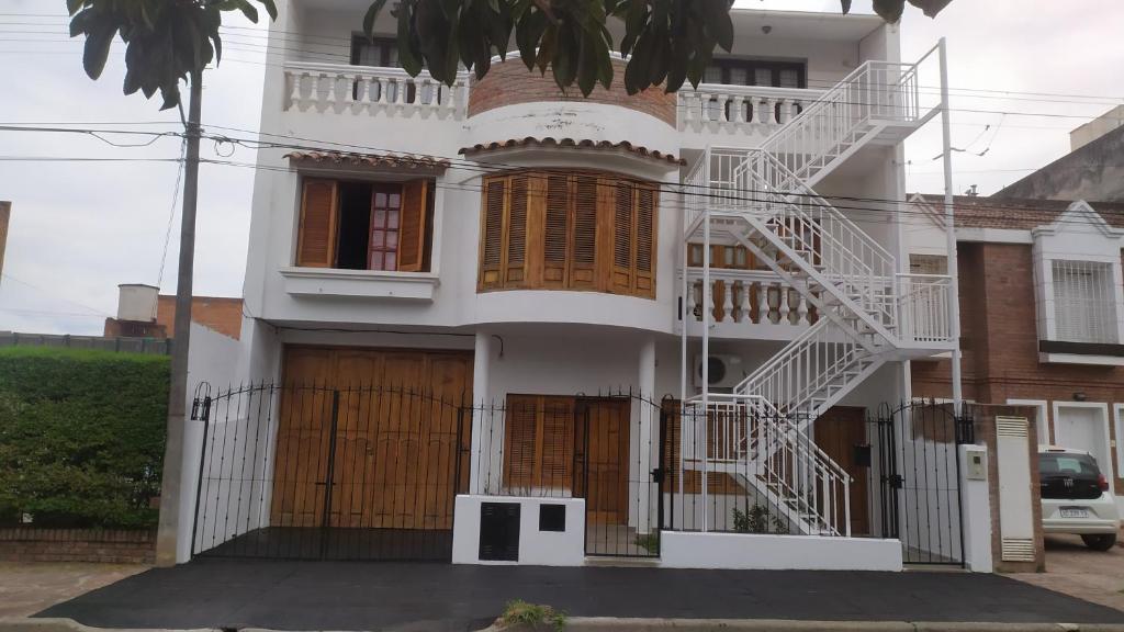 a white house with a white staircase on it at CASA BLANCA Jujuy in San Salvador de Jujuy
