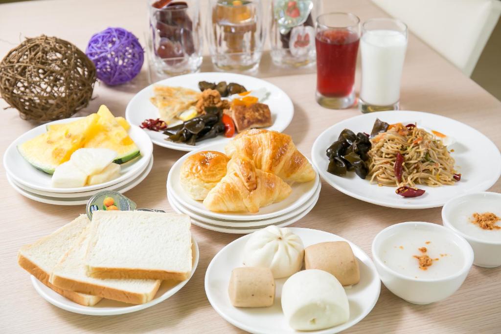 a table with plates of food on it at Sunseed International Villa Hotel in Chiayi City