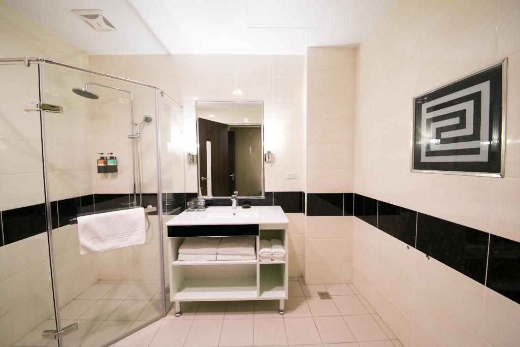 a bathroom with a sink and a shower at Sunseed International Villa Hotel in Chiayi City