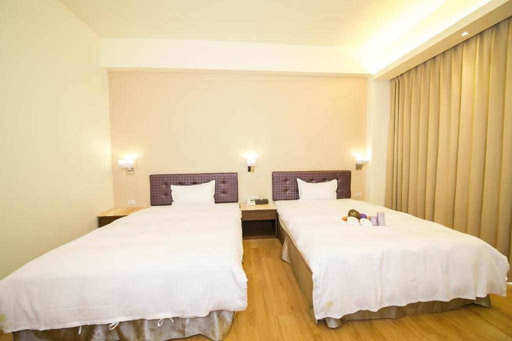 Postel nebo postele na pokoji v ubytování Sunseed International Villa Hotel