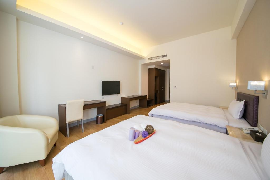 Postel nebo postele na pokoji v ubytování Sunseed International Villa Hotel