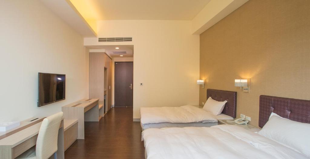 Postel nebo postele na pokoji v ubytování Sunseed International Villa Hotel