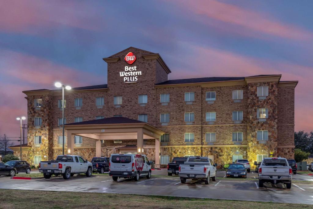 a hotel with cars parked in a parking lot at Best Western Plus DFW Airport West Euless in Euless