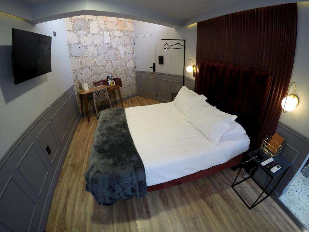 Postel nebo postele na pokoji v ubytování Casa Nada Hotel