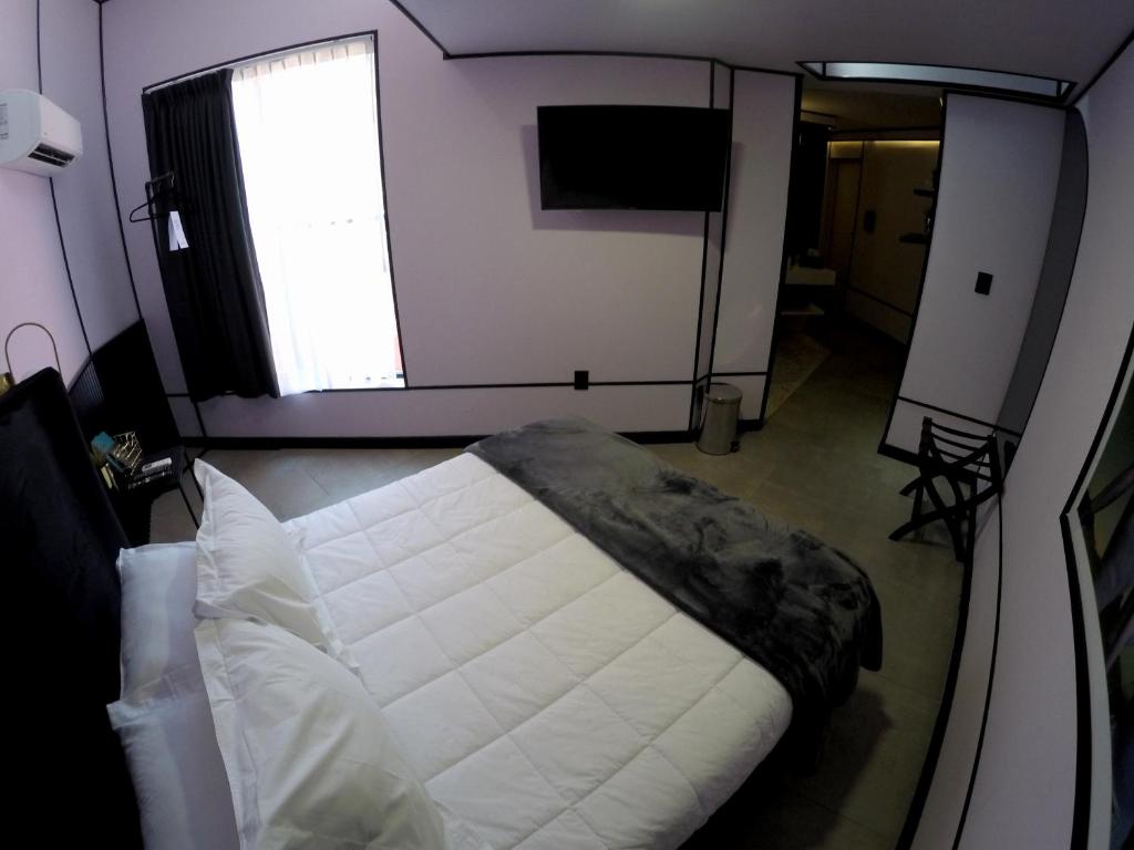 Postel nebo postele na pokoji v ubytování Casa Nada Hotel