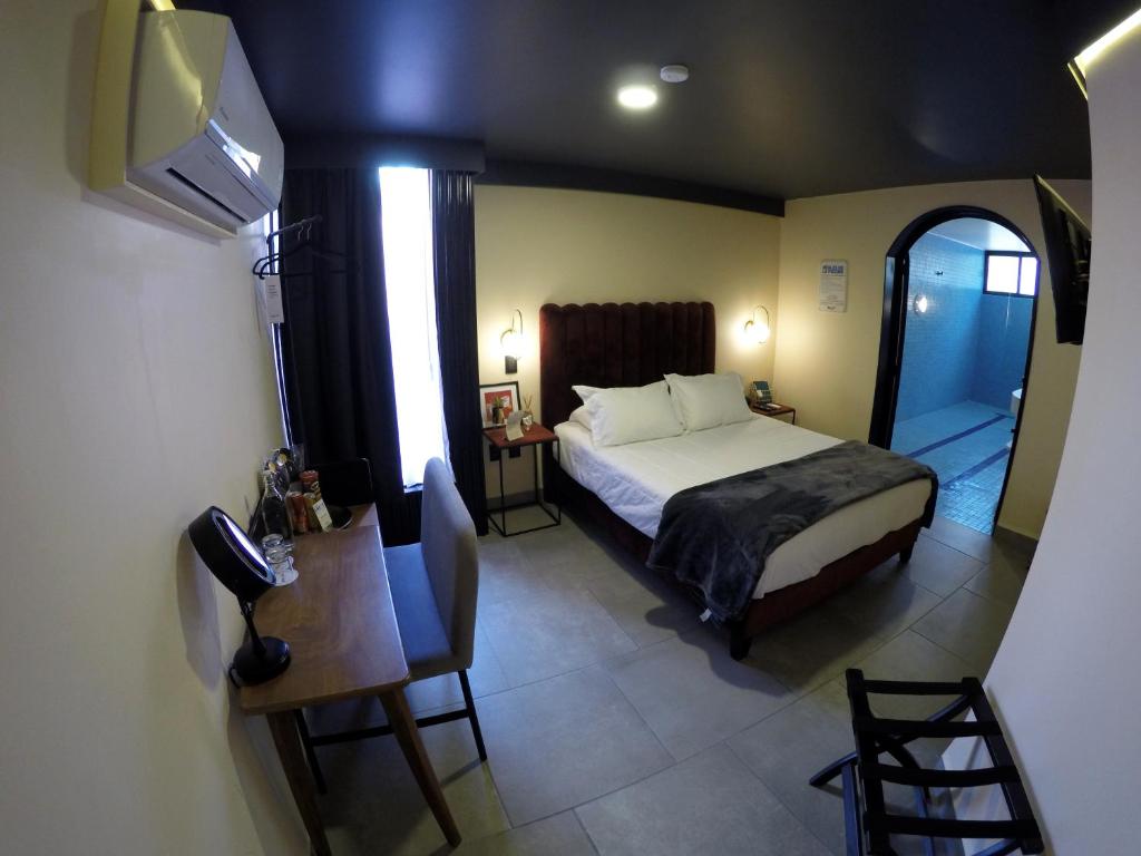 Postel nebo postele na pokoji v ubytování Casa Nada Hotel