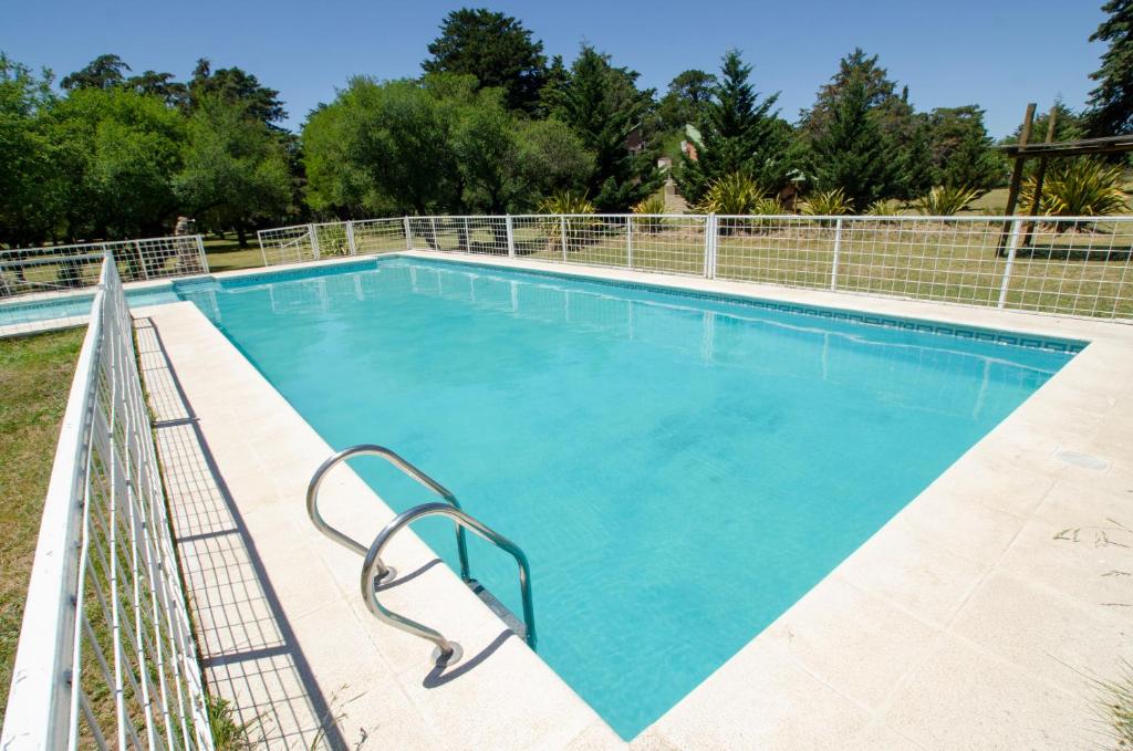 a large swimming pool with blue water at Ecoparque Kooch in Sierra de la Ventana