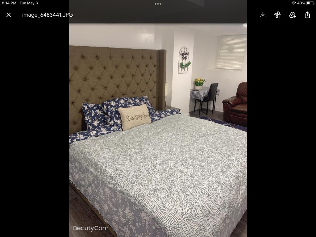 a bedroom with a large bed with a large headboard at Sweet and beautiful bedroom in Baltimore