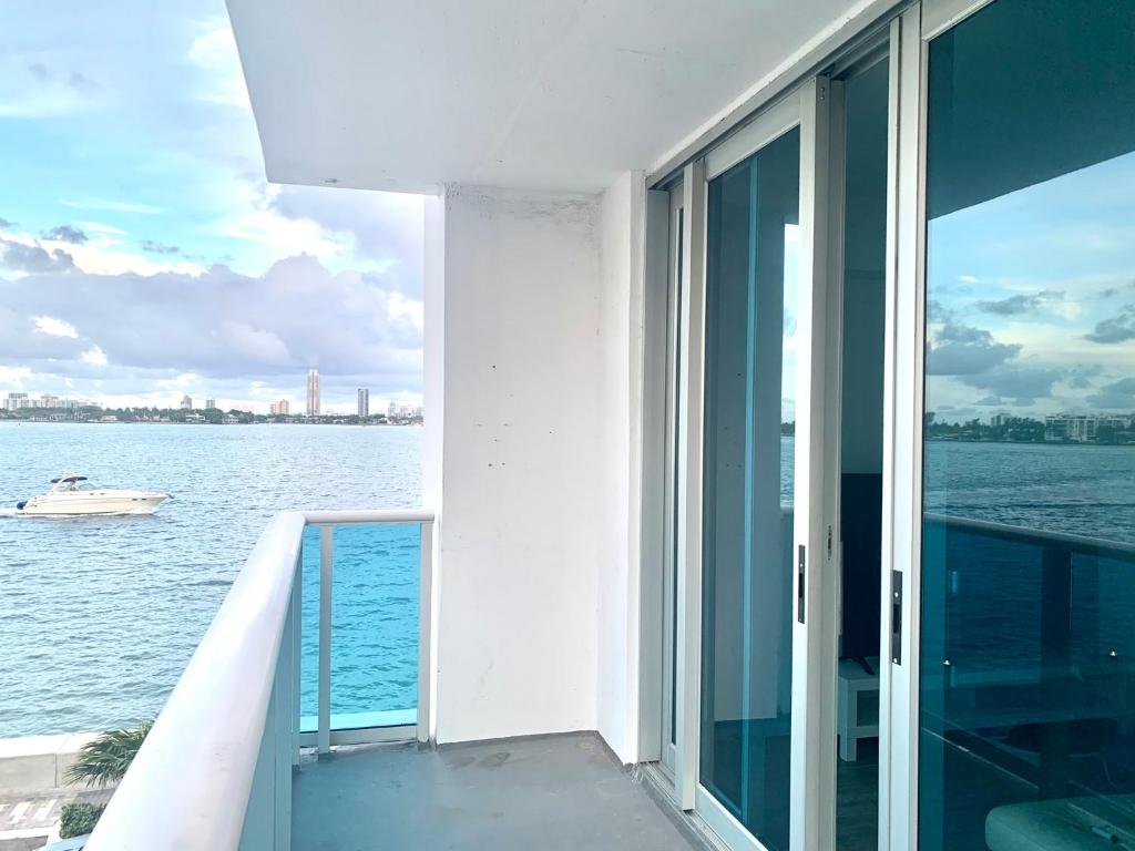 a balcony of a building with a view of the water at Great private room in Miami Beach