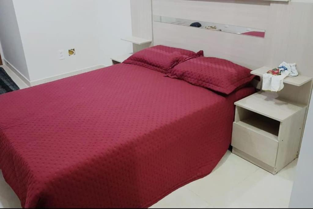 a bedroom with a red bed and a night stand at GORGEOUS FlatE Central London Liverpool St Station in London