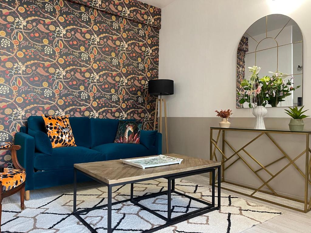 a living room with a blue couch and a table at Apartment- La Rochelle historic city centre in La Rochelle