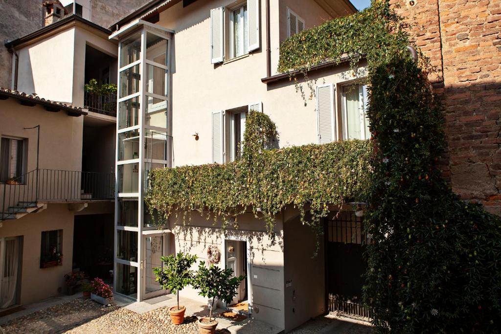 a building with ivy on the side of it at Locanda San Bernardo in Vigevano