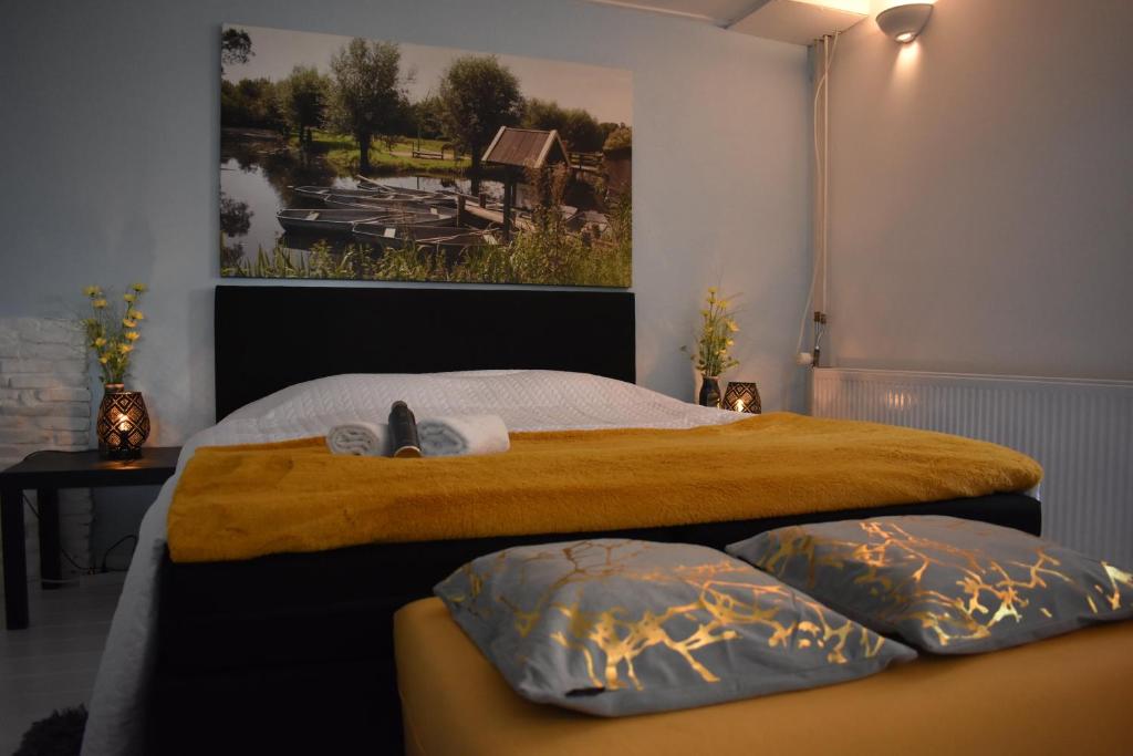 a bedroom with a large bed with two pillows at BenB de Walvis in Krimpen aan de Lek