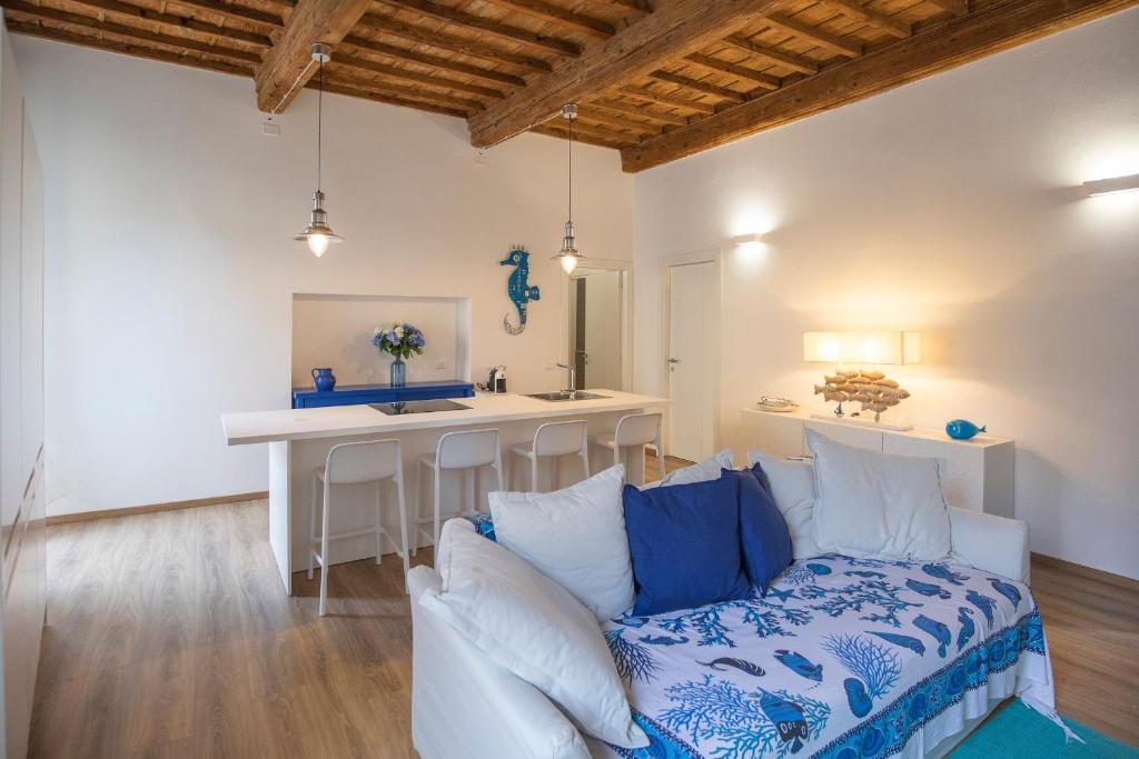 a living room with a couch and a table at HelloElba Appartamento Mascalzone Latino in Portoferraio