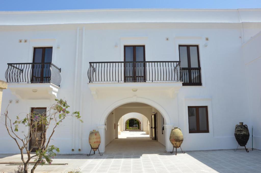 a white building with an archway and windows at MARE NOSTRUM in Fasano