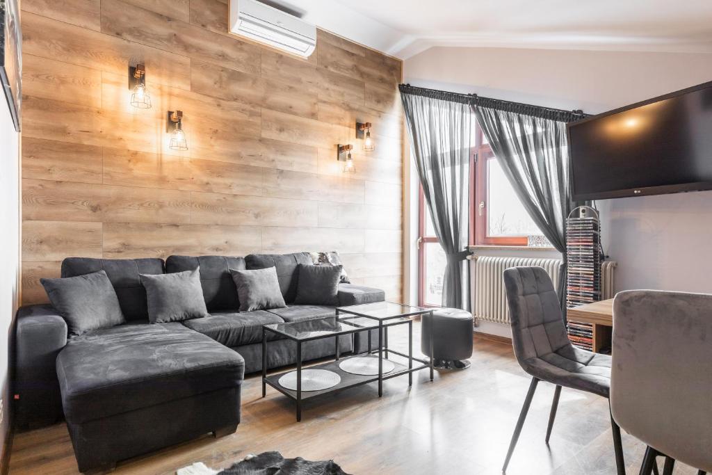 a living room with a couch and a table at Apartament Top Zakopane in Zakopane