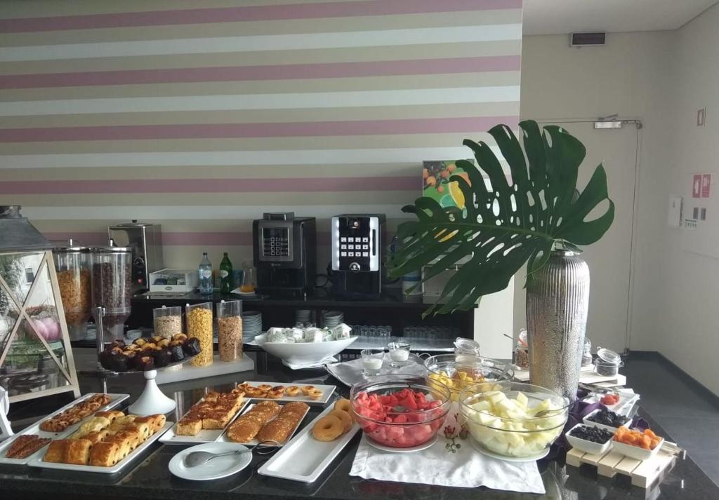 a buffet with many different types of food on a table at Hotel Monte Lírio in Espinho