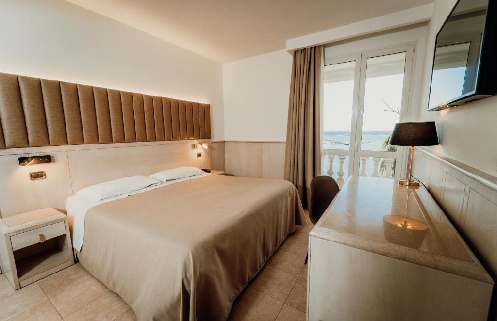 Postel nebo postele na pokoji v ubytování Hotel Falli
