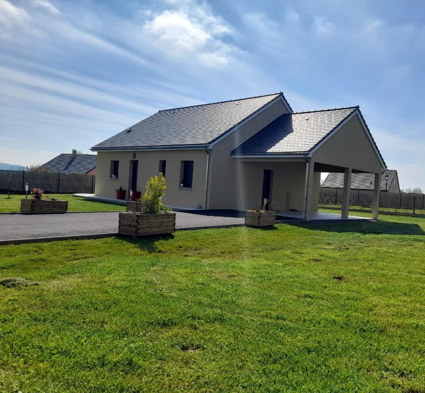 a large white house with a grass yard at Maison de 2 chambres avec jardin clos et wifi a Coltines in Coltines