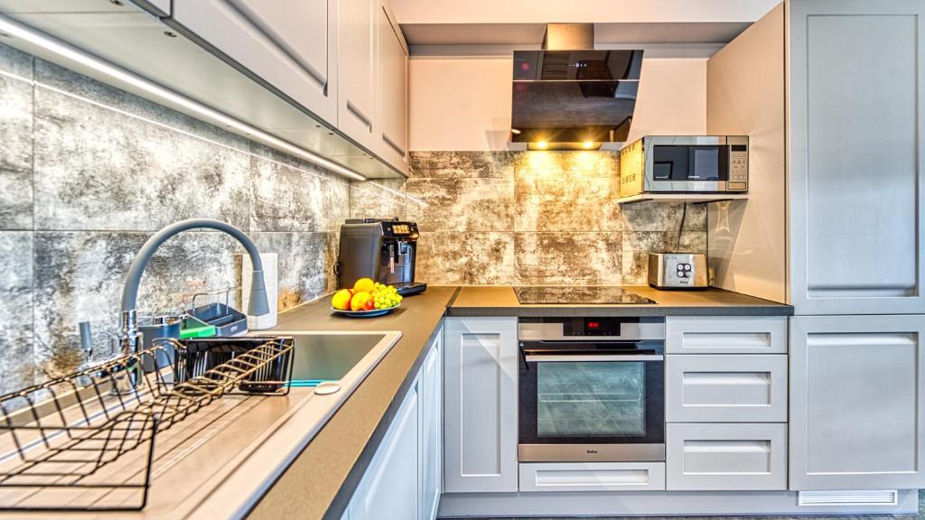Kuchyňa alebo kuchynka v ubytovaní Apartament IZER ZONE 21 z Sauną ogólnodostępną - 5D Apartamenty