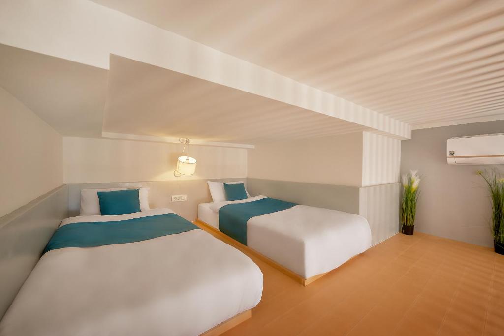 Postel nebo postele na pokoji v ubytování Garni Hotel Larimar