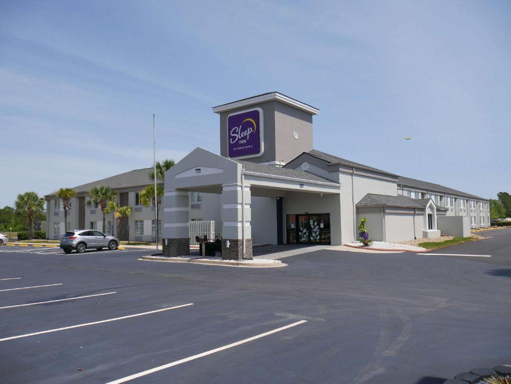 a mobil gas station with a car parked in a parking lot at Sleep Inn near Outlets in Myrtle Beach